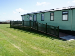 Green foiled deck to with ramp disabled access skirting holiday home decking steps park estate lodge installers suppliers manufacturers sundecks vinyl plastic skirting deck board pvc upvc extrusion polymer composite wpc wood free galvanised steel sub-frame